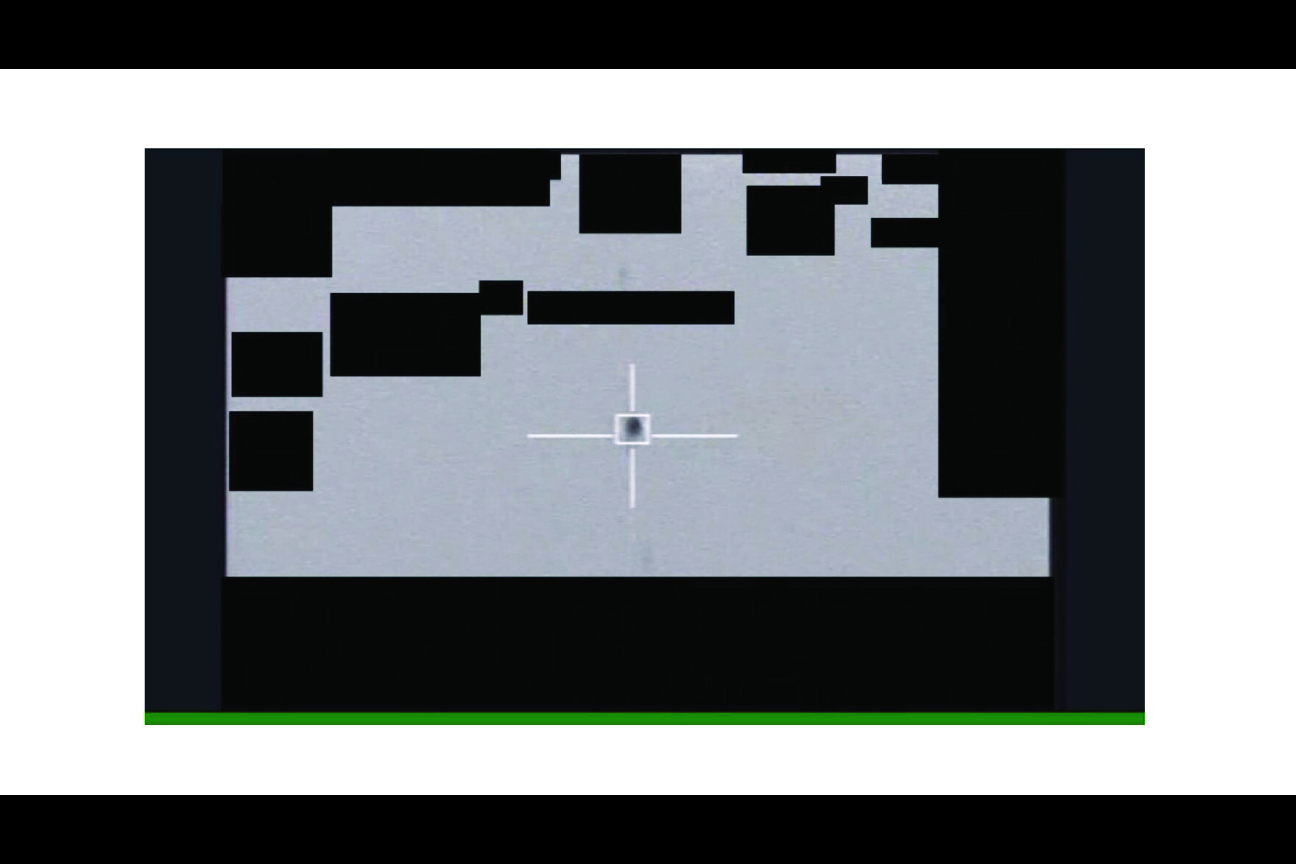 Sensor view with a crosshair on an object, with redacted portions.
